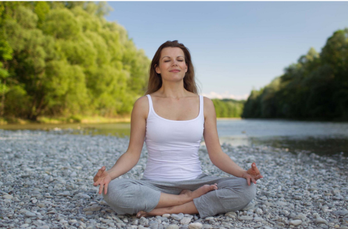 Uma mulher meditando na natureza